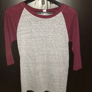 Grey/ maroon sleeved shirt.